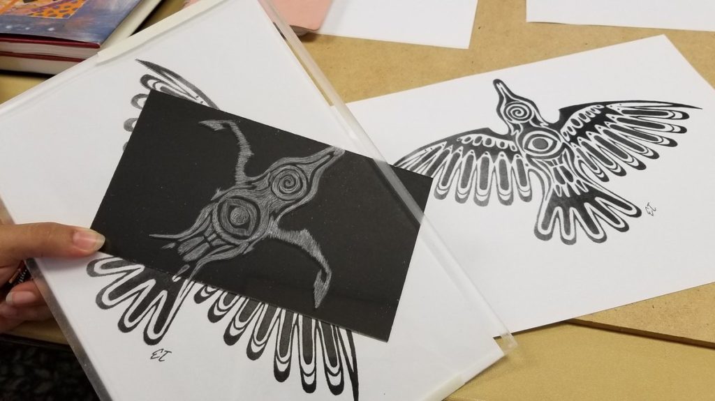 black and white work in progress, Haida-style raven being etched into plexiglass